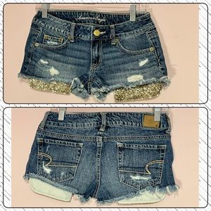 AMERICAN EAGLE OUTFITTERS JEANS SHORTS w/ GOLD SEQUIN POCKETS…Sz 0 NWOT